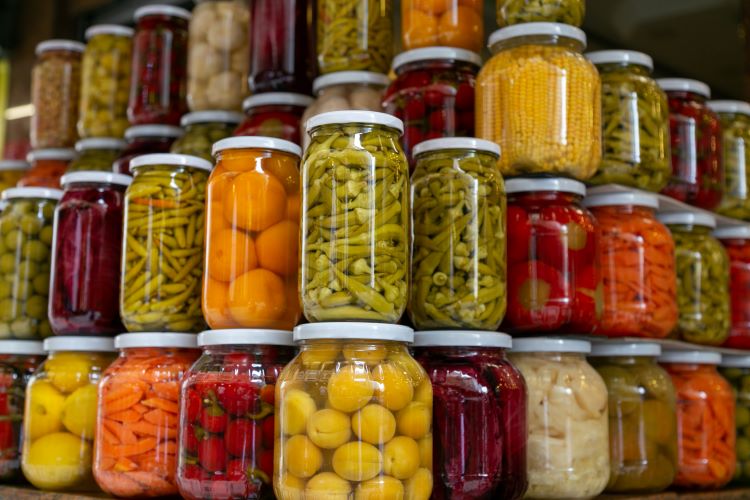 Various preserved pickled vegetables in glass jars. Marinated food and organic raw vegetables, canned homemade food concept. Preservation and storage of vegetarian food for the winte